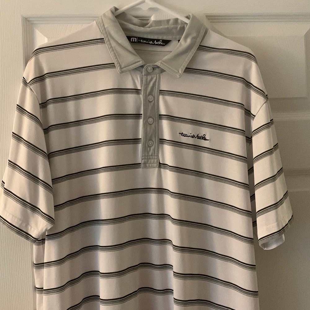 Shirt is white with grey trim/stripes .Cascata logo on back of left sleeve.